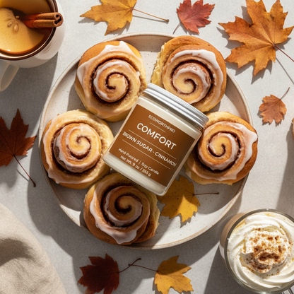ECOWORTHPRO COMFORT brown sugar and cinnamon fall candle burning beside fresh cinnamon rolls