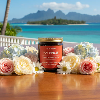 ECOWORTHPRO HAPPINESS tropical fruit blend eco-friendly candle in reusable glass jar surrounded by colourful roses on a deck overlooking a peaceful island sea