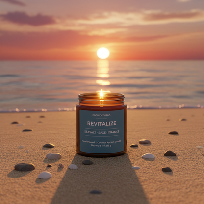 ECOWORTHPRO REVITALIZE sea salt and patchouli hand-poured scented candle burning on beach sand with seashells and stones at sunset